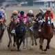 Justify and Mike Smith lead heading into the far turn, flanked by Restoring Hope and Florent Geroux.